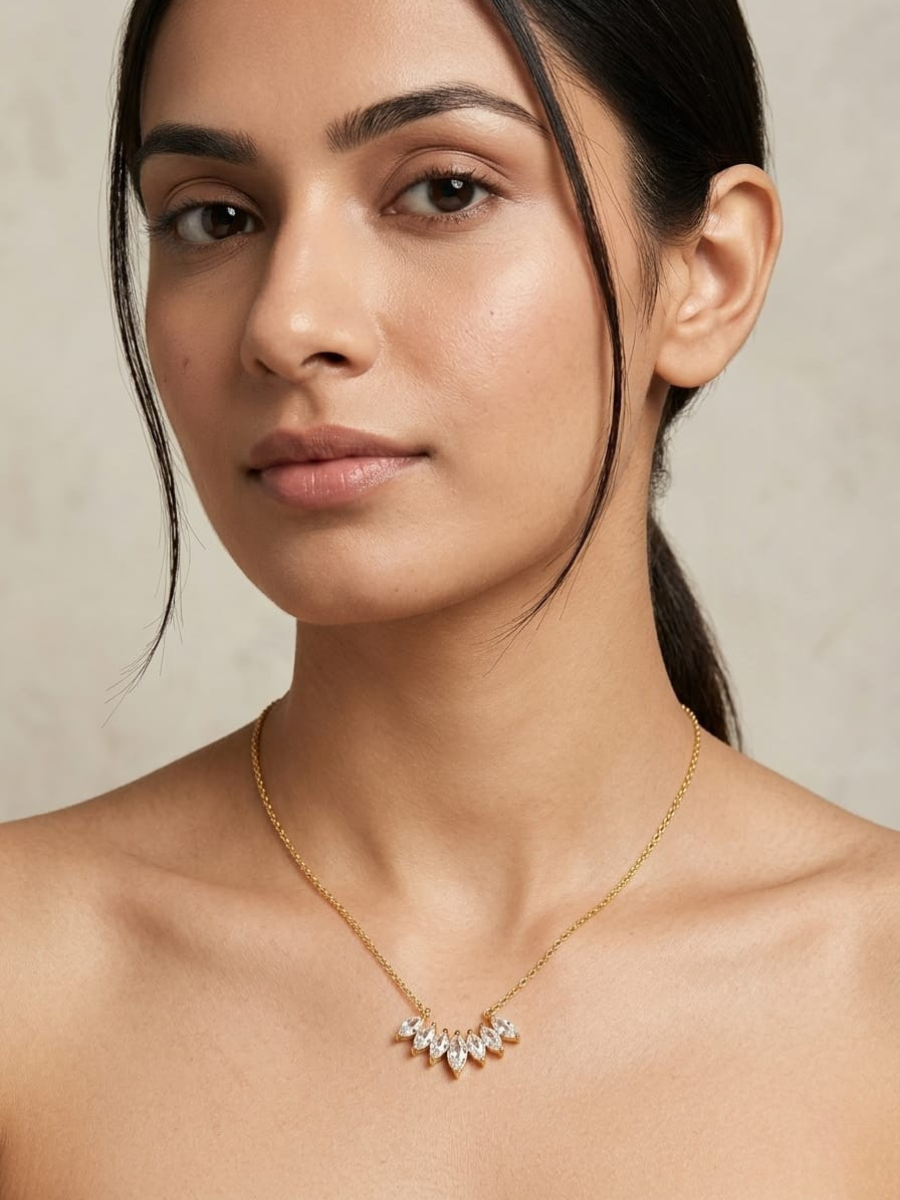 A model is wearing our 18K Gold Finish Celestia Crystal Cluster Chain Necklace