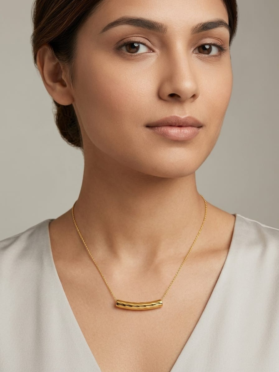 A woman is wearing our 18K Gold Plated Curved Bar Pendant Chain Necklace