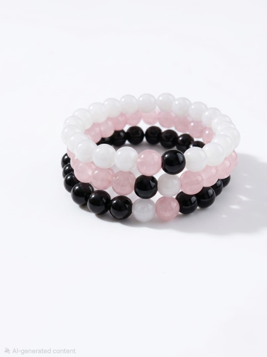 Set of three beaded bracelets in pink, black, and white