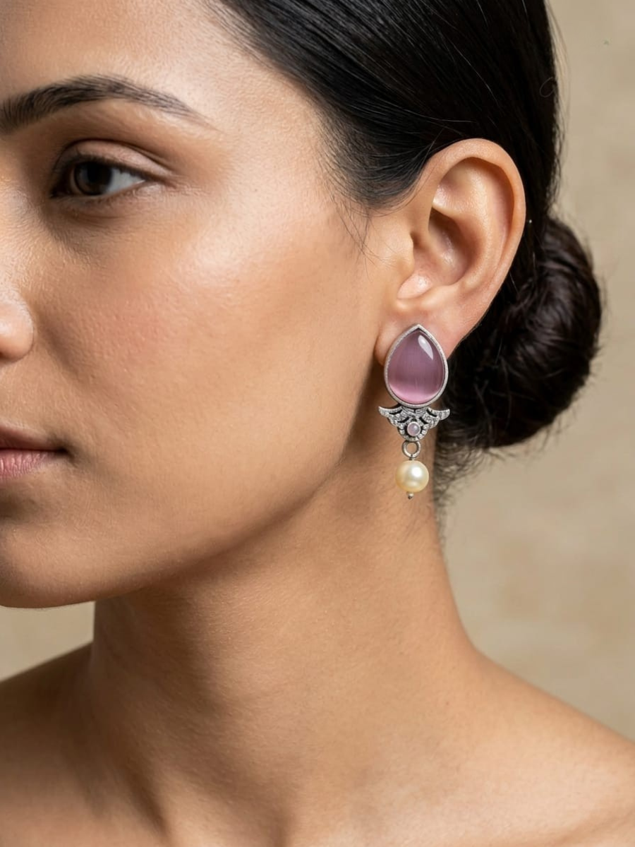 A model is wearing our Baby Pink Stone Studded Oxidised Silver Stud Earrings