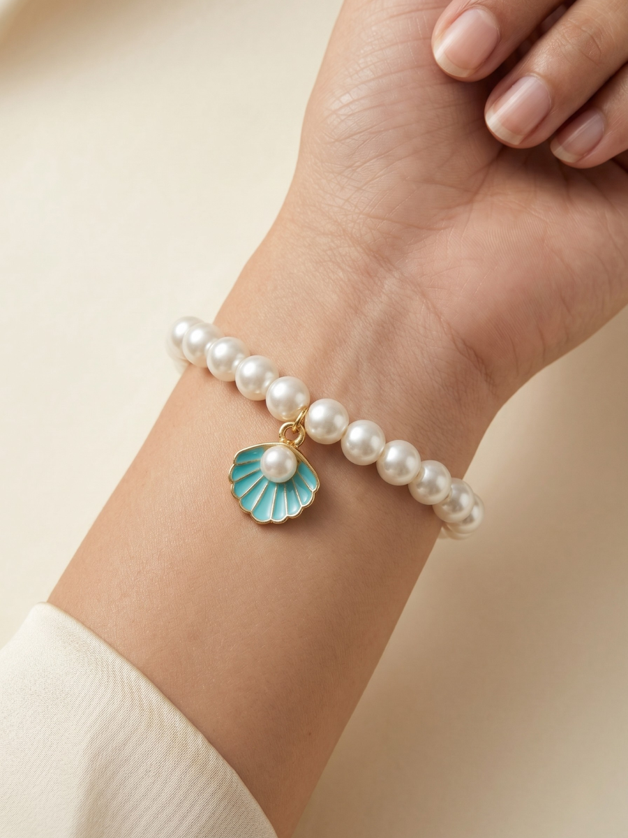 A model is wearing our Blue Shell Charm White Pearls Beaded Handmade Bracelet