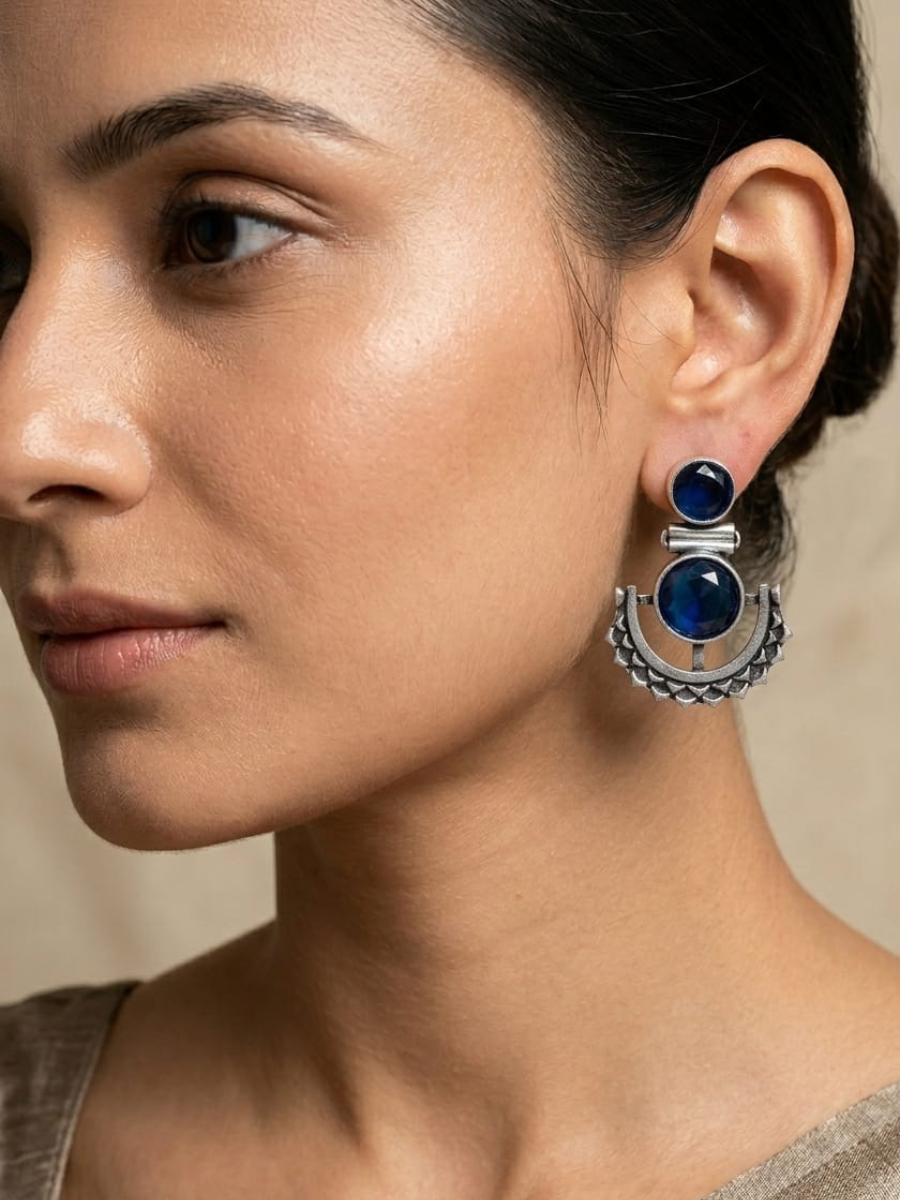 A model is wearing our Blue Stone Studded Oxidised Silver Dangler Earrings