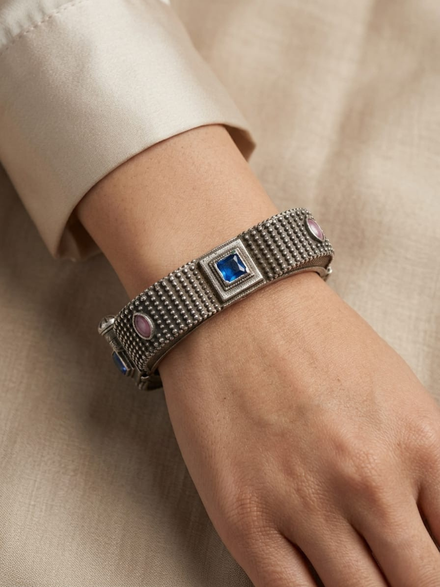 A model is wearing our Blue and Baby Pink German Silver Oxidised Square Kada Bracelet