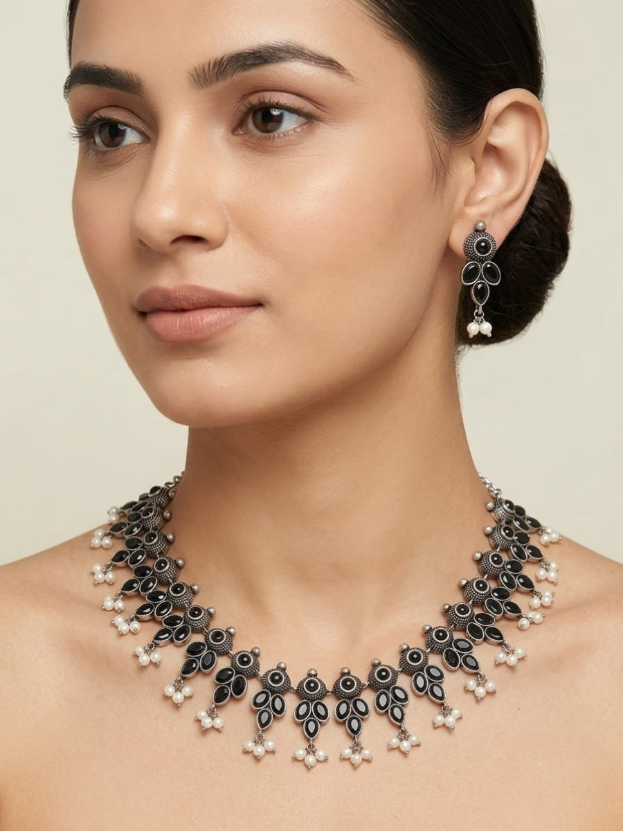 A model is wearing our Classic Black Stone Oxidised Silver Necklace Set with Earrings