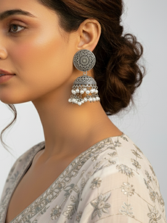 An Indian Model wearing our Classic German Silver Oxidised Jhumka Earrings with Pearls