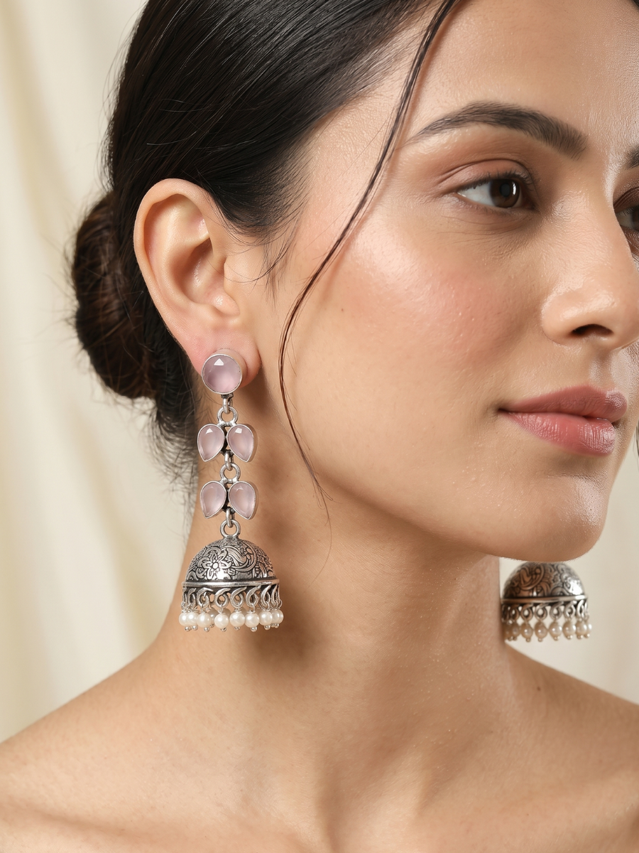 A model is wearing our Elegant Baby Pink Stones Oxidised Silver Drop Jhumka Earrings