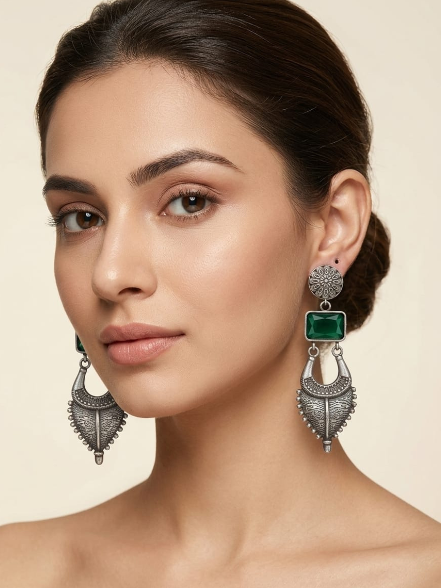 A model is wearing Green Long tribal silver drop earrings
