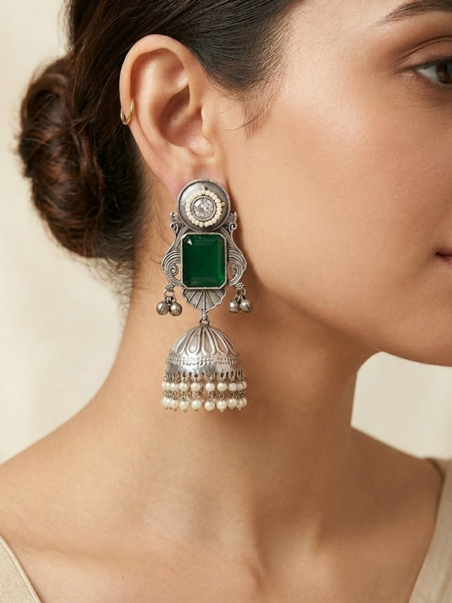 A model is earing our Green Stone Studded Big Oxidised Silver Jhumka Earrings