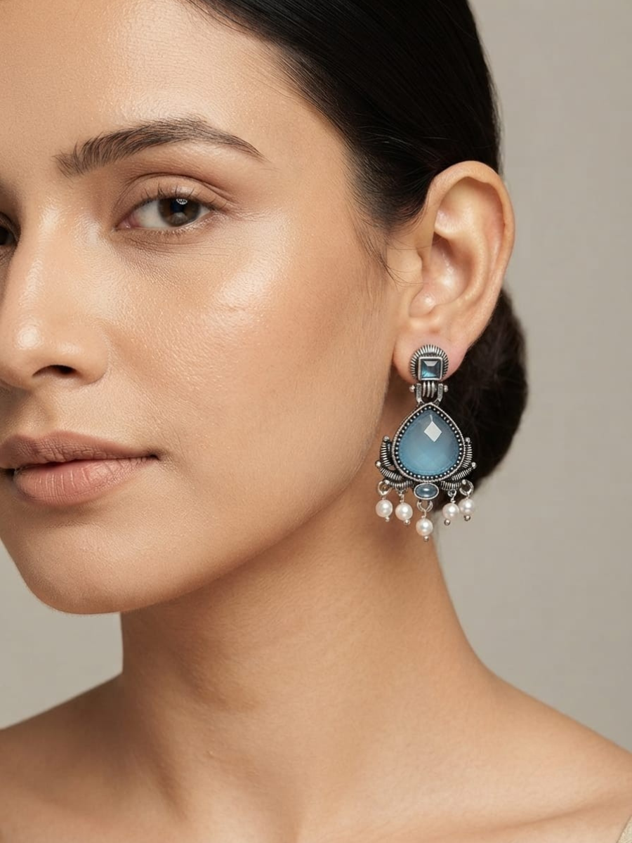 A women wearing our Oxidised silver blue stone earrings