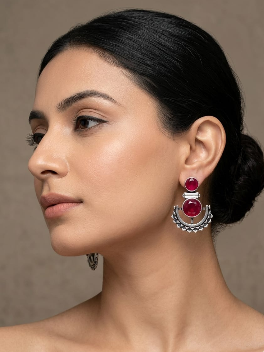 A model is wearing our Ruby Red Stone Studded Oxidised Silver Dangler Earrings