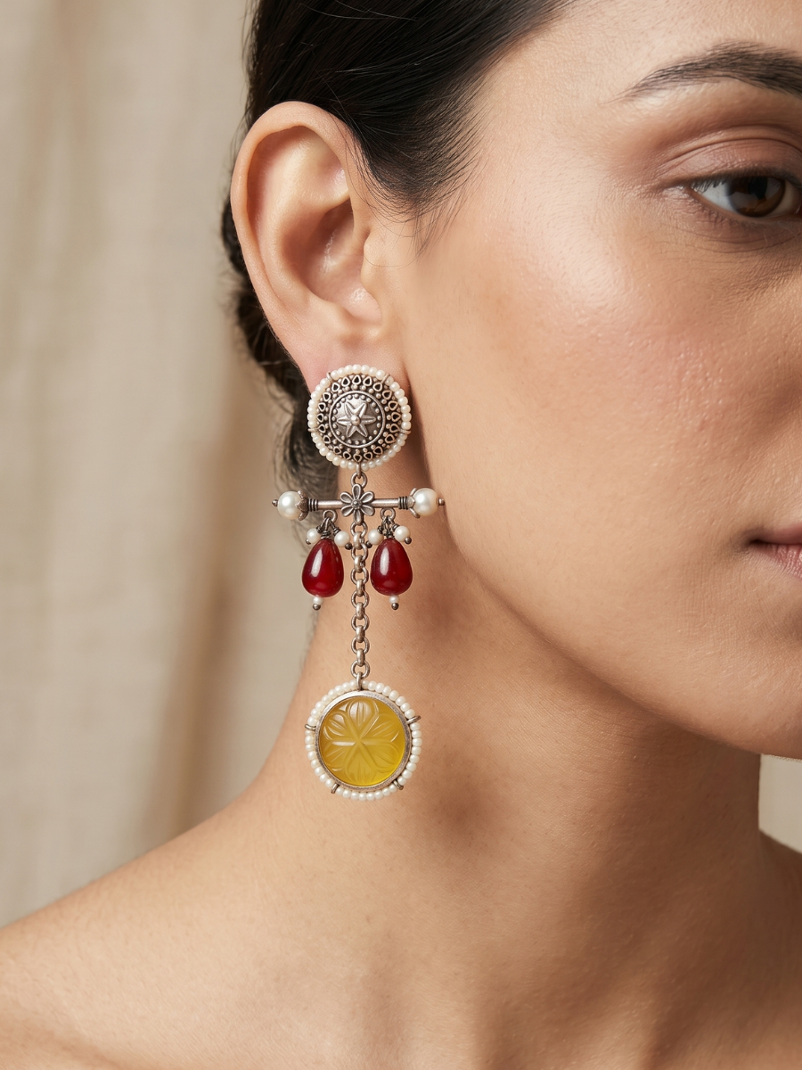 A model is wearing our Ruby Red and Yellow Stone Oxidised Silver Drop Earrings