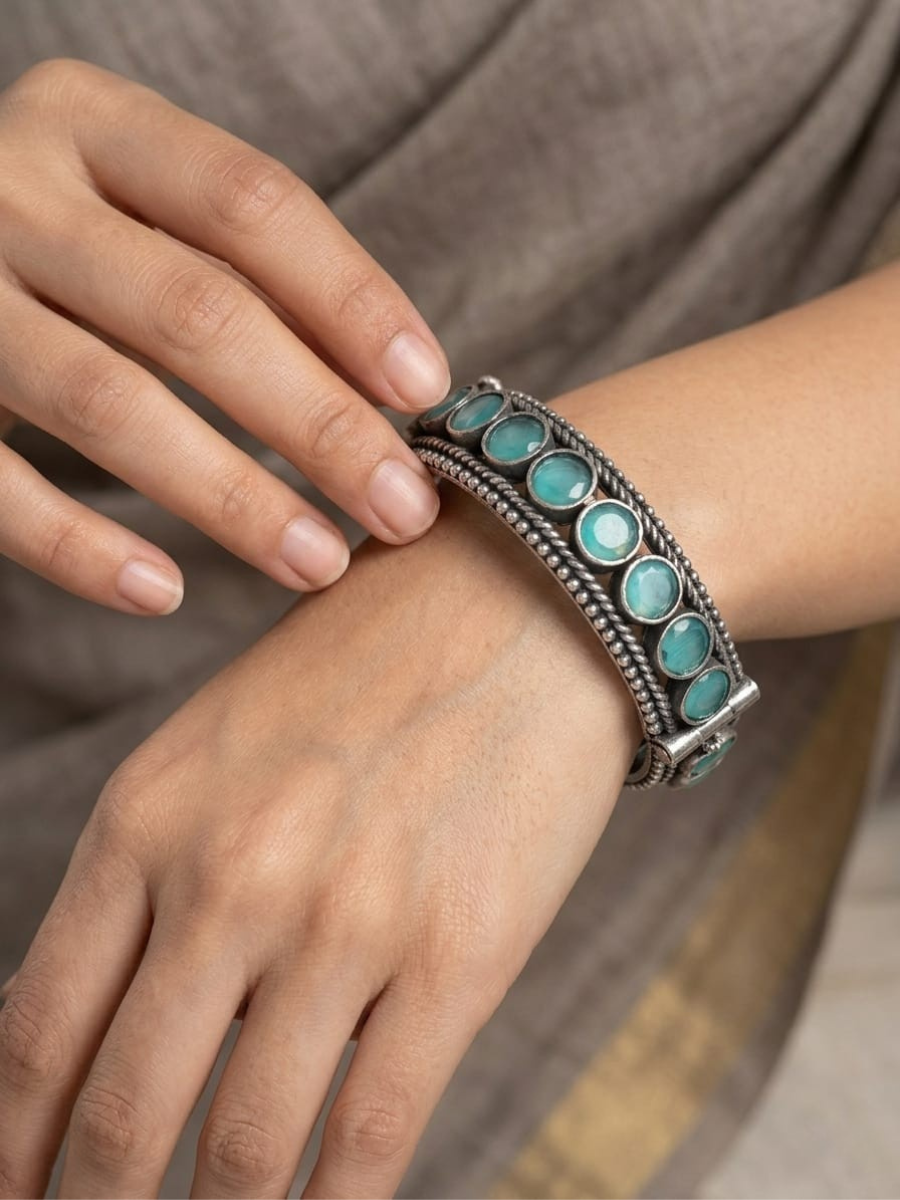 A model is wearing our Sea Green Round Stone German Silver Oxidised Bangle