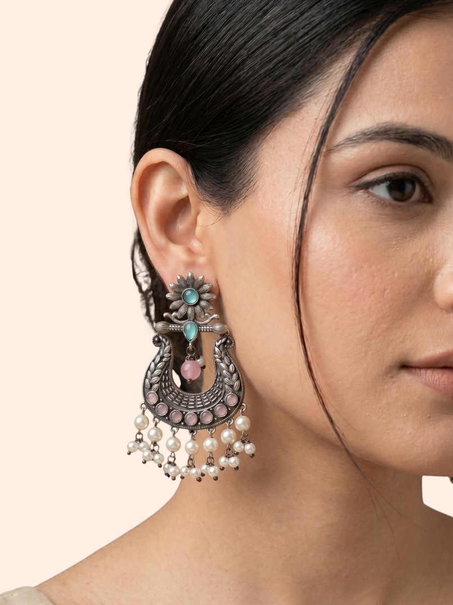A model is wearing our Sea Green and Pink German Silver Oxidised Chandbali Pearl Earrings