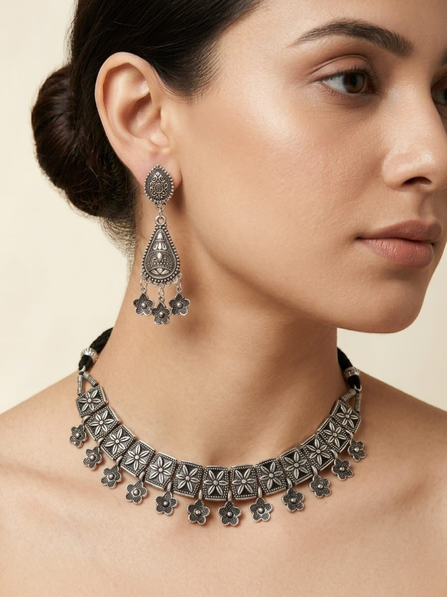 A model is wearing our Traditional Floral Oxidised Silver Choker Necklace Set