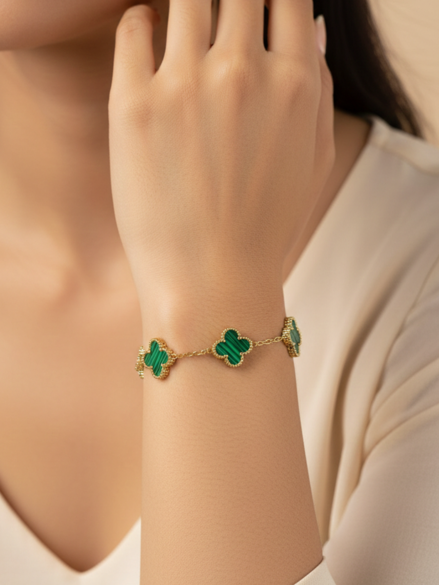 Gold bracelet with green clover-shaped charms