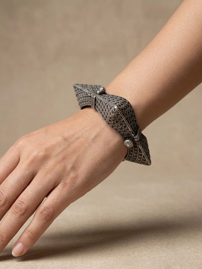 A model is wearing our Antique Oxidised German Silver Hand-Cuff Kada