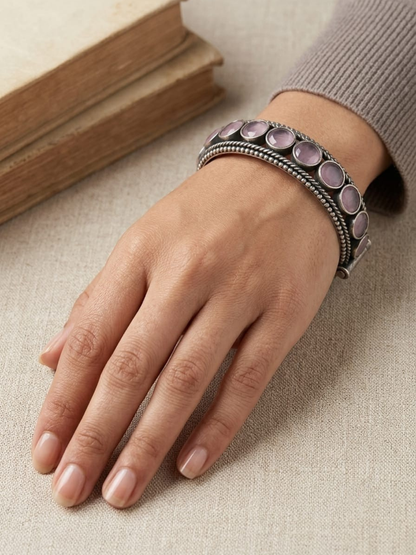 A model is wearing our Baby Pink Round Stone German Silver Oxidised Bangle