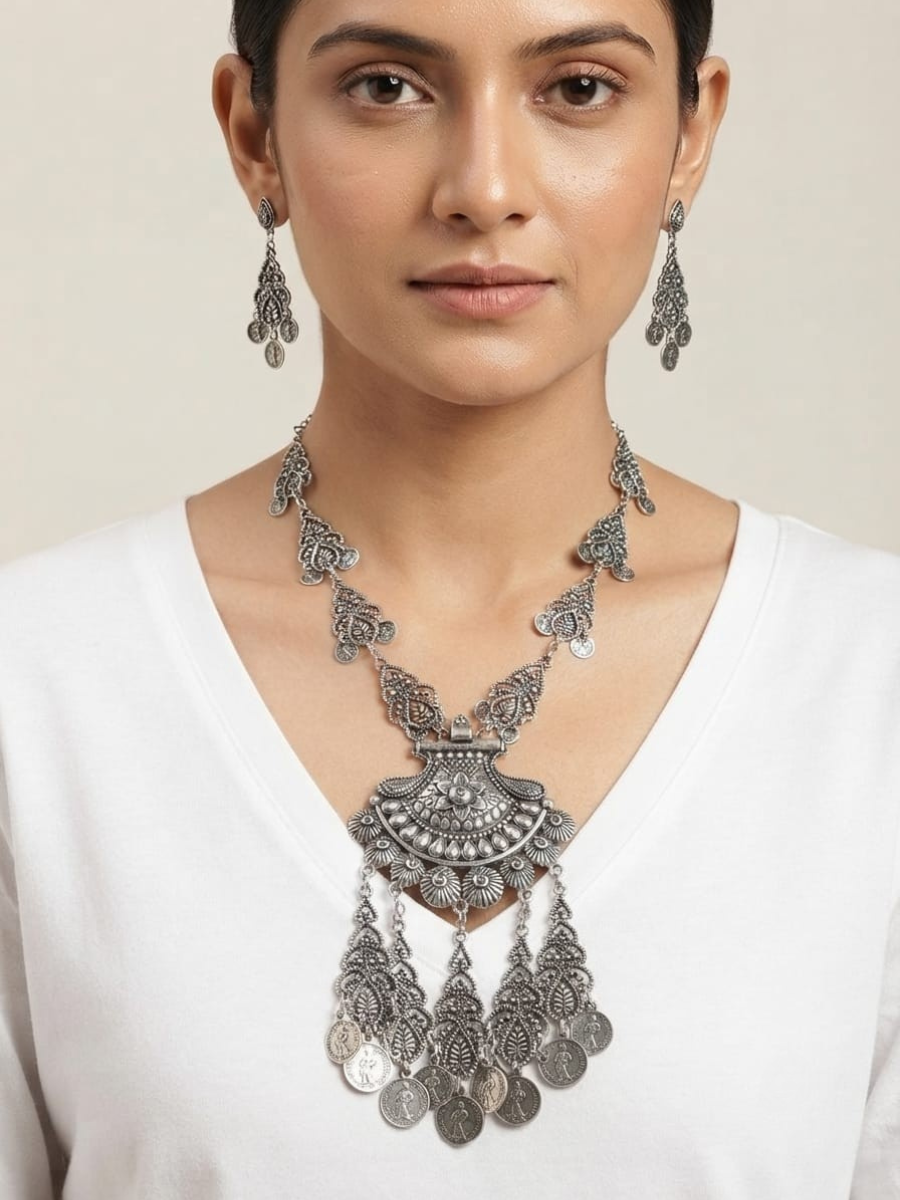 A model is wearing our Black Metal Long Oxidised Silver Necklace Set with Earrings