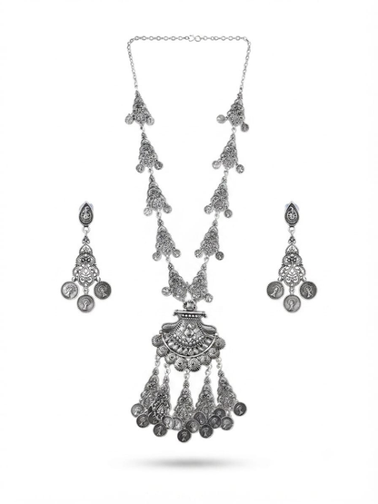 A silver-toned traditional jewelry set featuring a long chain necklace with multiple dangling coin-style charms, matching drop earrings, and a decorative pendant