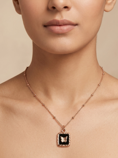 A model is wearing our Black Square Butterfly Pendant Rose Gold Chain Necklace
