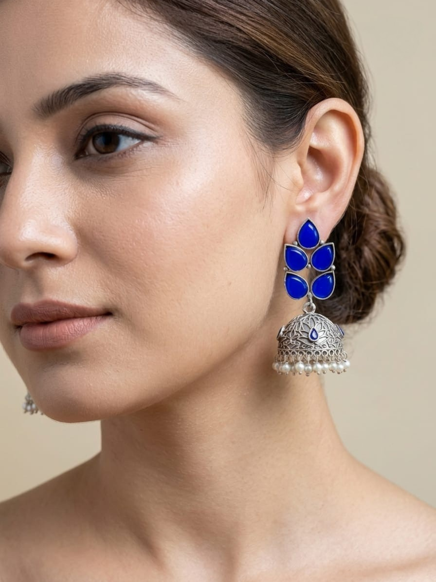 A model is wearing our Blue Stones Leaf Shaped Big Oxidised Silver Jhumka Earrings