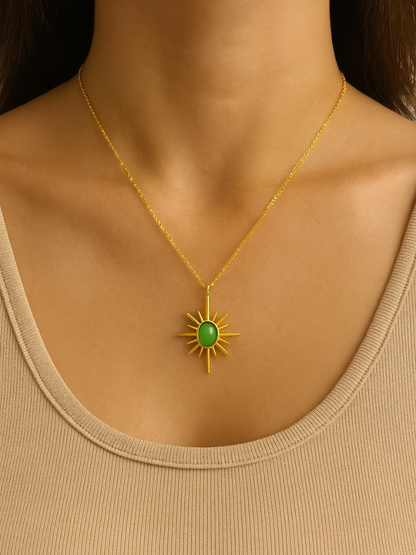 Gold necklace with a green sun charm pendant