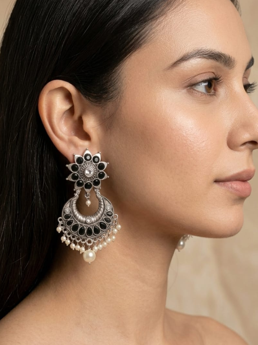 A model is wearing our Classic German Silver Oxidised Black Stone Dangle Earrings