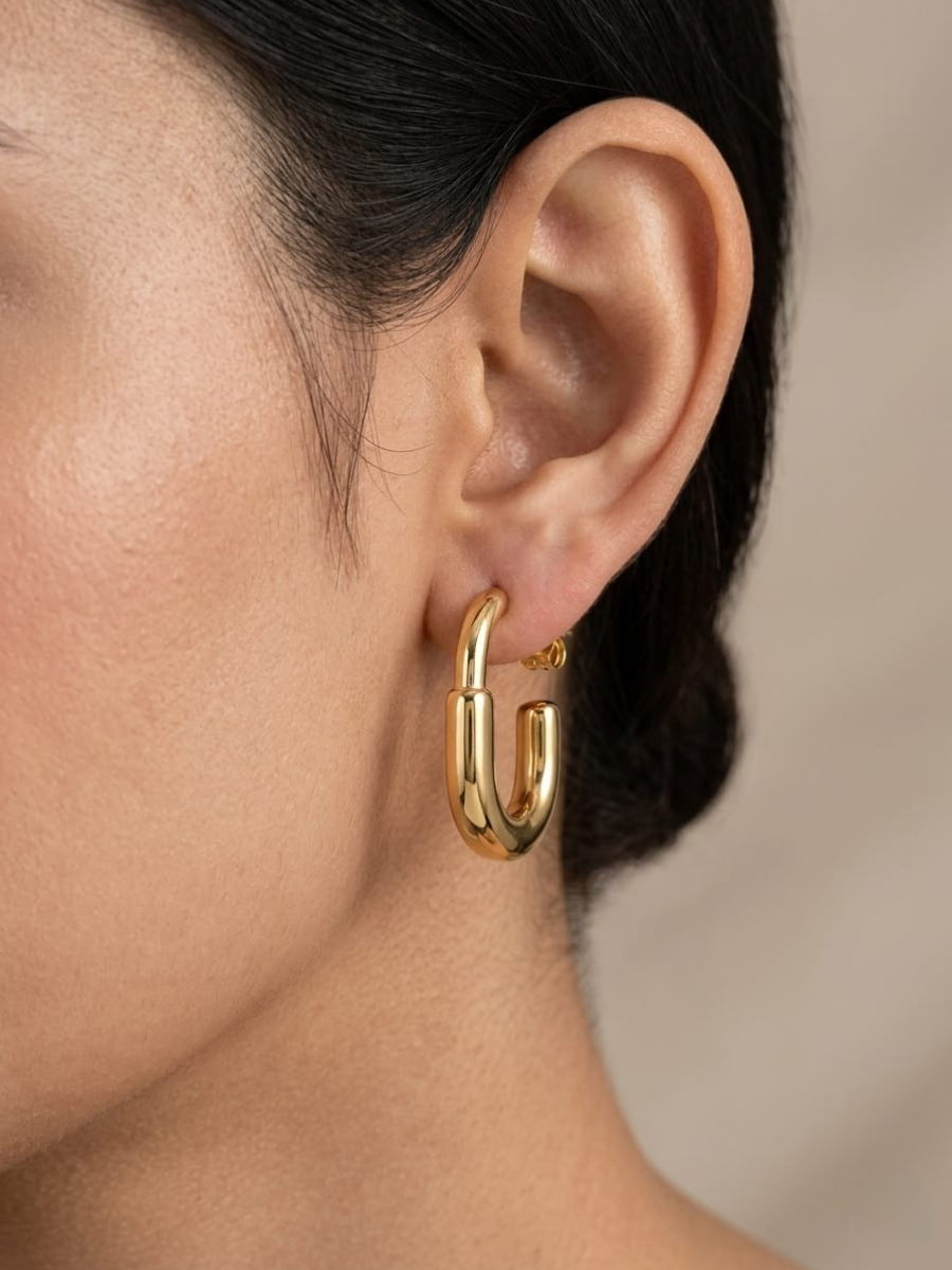 A model is wearing our Classic Golden Plated Minimal Hoop Earrings