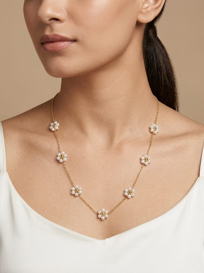 A model is wearing our Dainty White Beaded Flower Charms Golden Chain Necklace
