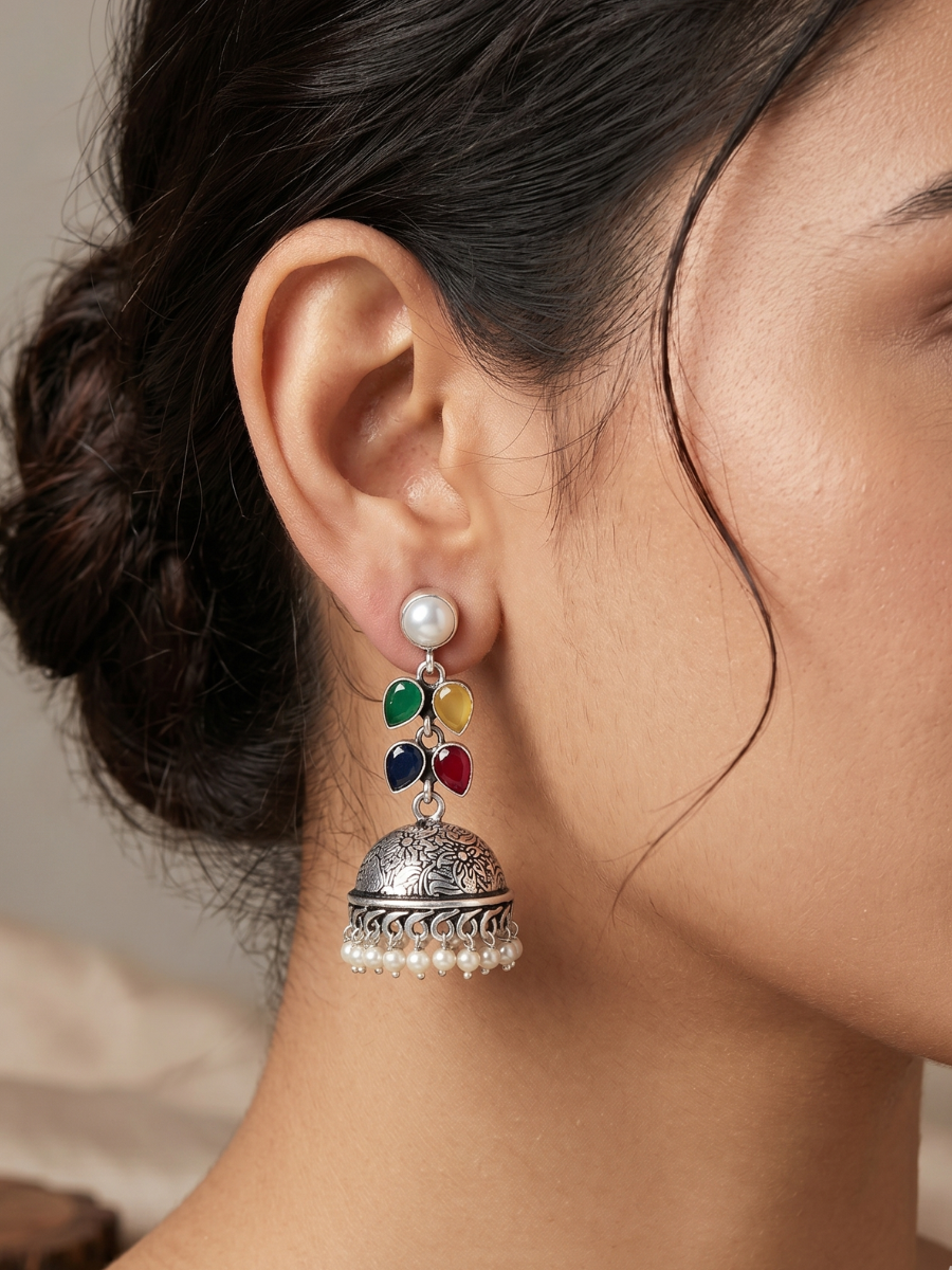 A model is wearing our Elegant Colourful Stones Oxidised Silver Drop Jhumka Earrings