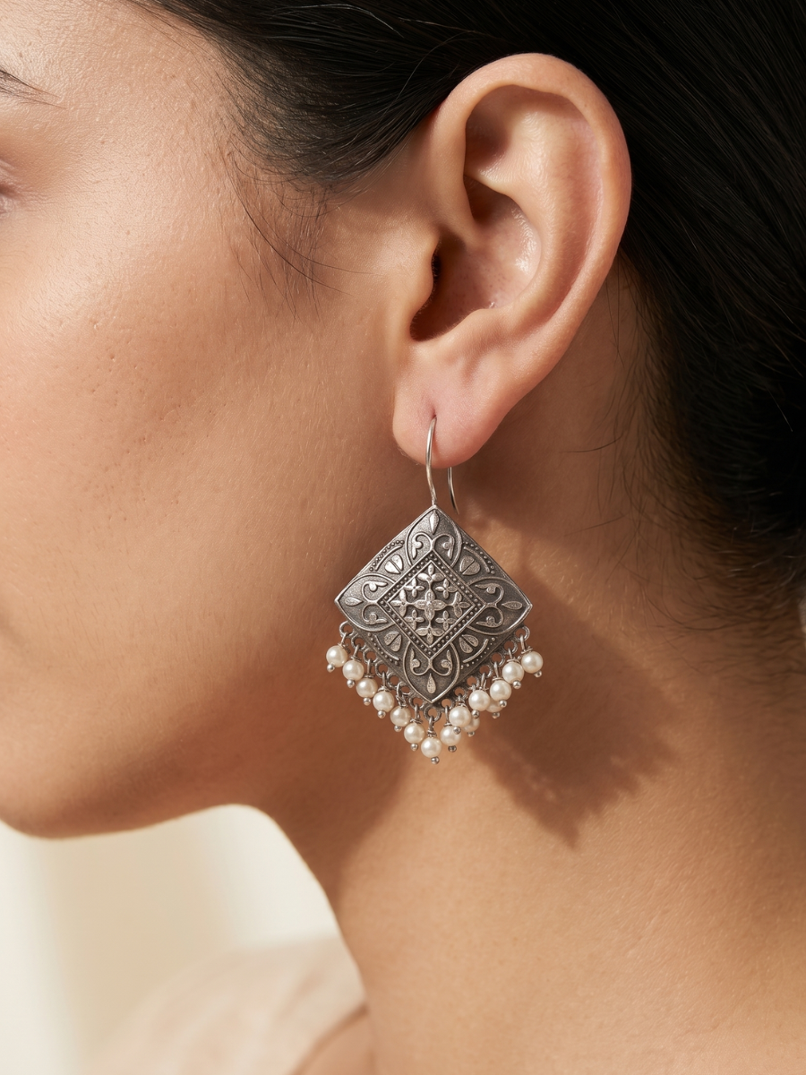 A model is wearing our German Silver Black Metal Square Shaped Hook Earrings