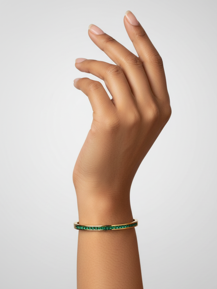 Gold bangle with green stones