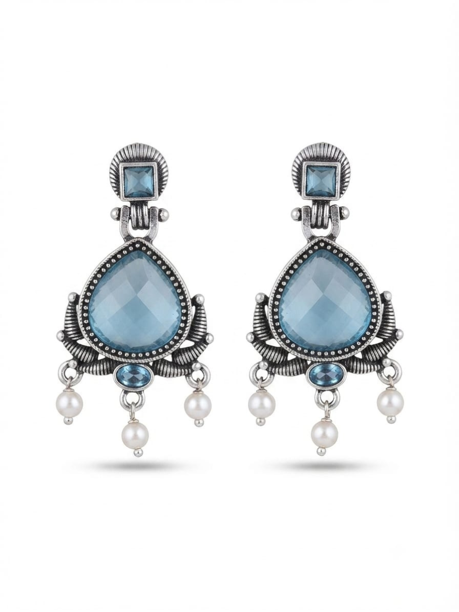 A pair of silver-toned statement dangle earrings featuring faceted light blue teardrop-shaped crystals, smaller blue stones, and dangling white pearl beads