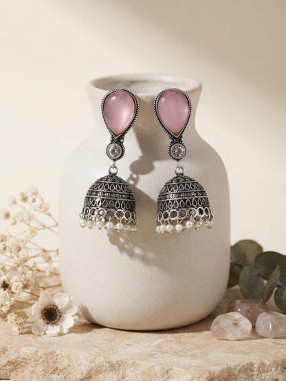 Oxidized silver jhumka earrings with a teardrop-shaped pink stone and pearl drops
