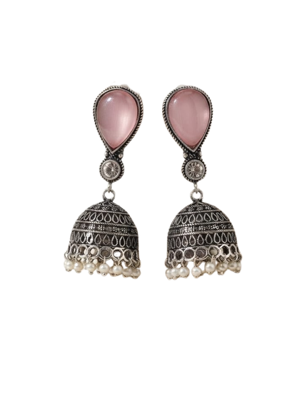 Silver-toned alloy jhumka earrings with an antique finish, a smooth pink center stone, and small pearl hangings