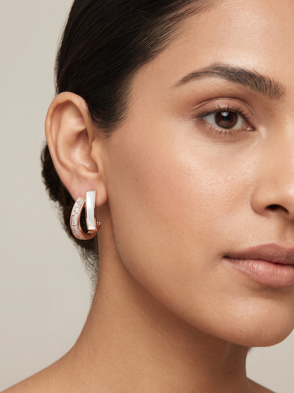 A model is wearing our Rose Gold White Stone Stud Earrings