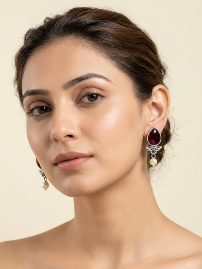 A model is wearing our Ruby Red Stone Studded Oxidised Silver Stud Earrings