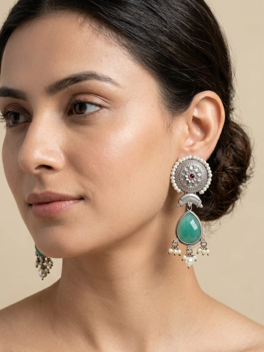 A model is wearing our Sea Green Stones German Silver Oxidised Dangler Earrings