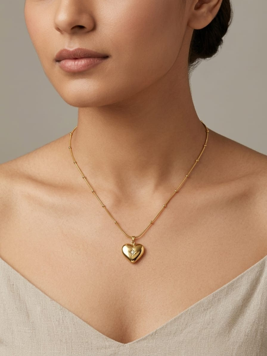 A model is wearing our Shiney Love Drop Heart Pendant Golden Chain Necklace