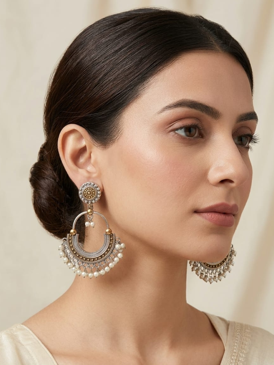 A model is wearing our Silver Plated Dual Tone Oxidised Chandbali Earrings