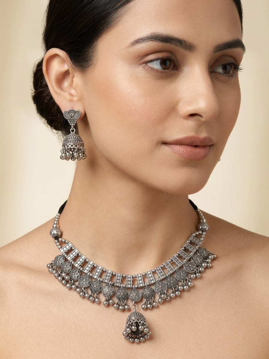 A model is wearing our Traditional Oxidised Silver Gungroo Choker Necklace Set